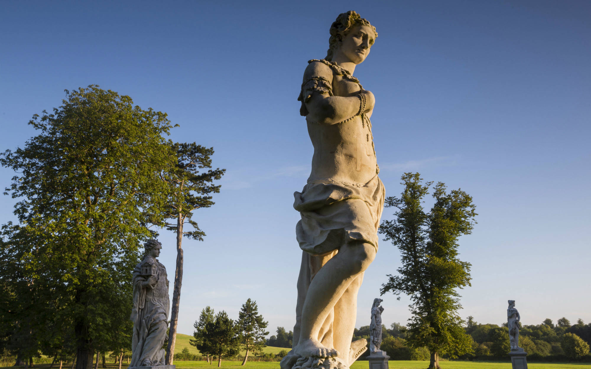 4 continents statues, located by the entrance drive to Waddesdon manor