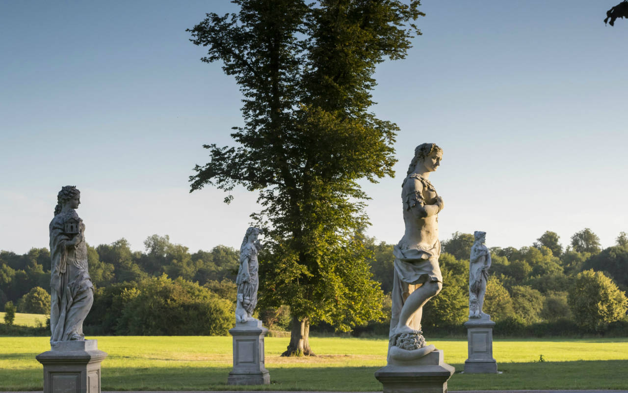 4 continents statues, located by the entrance drive to Waddesdon manor