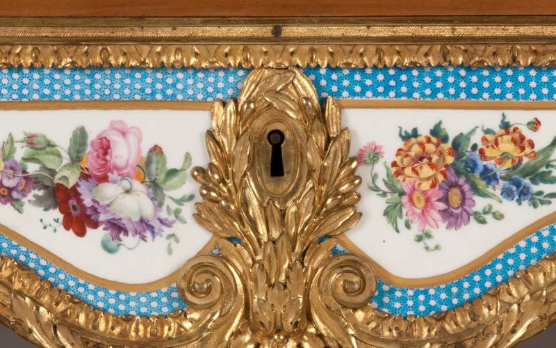 Rectangular fall-front desk with gilt-bronze mounts and ten Sèvres plaques with turquoise borders and baskets of flowers.