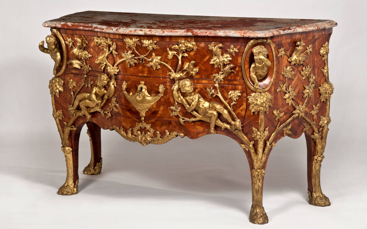 Chest of drawers with elaborate gilt-bronze mounts depicting oak branches and children reclining.