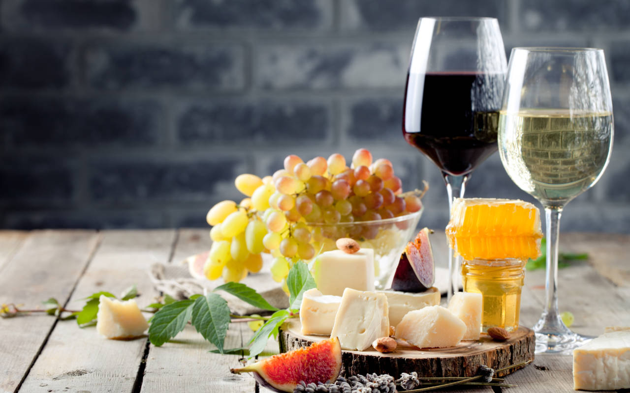 A selection of cheese and wine laid out on a table