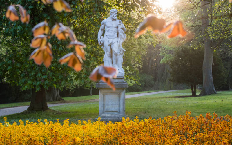 statue viewed through autumn leaves