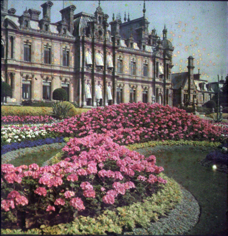 1910 auto-chrome of the colourful parterre at the south of the manor