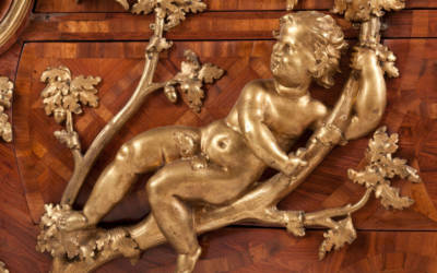 Chest of drawers by Charles Cressent with elaborate gilt-bronze mounts depicting oak branches and children reclining, c. 1730