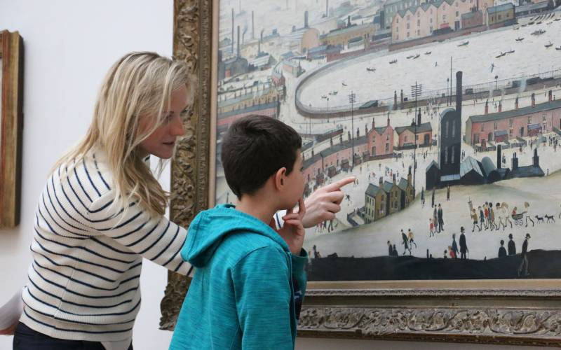 Child looking at a painting with the Little Grand Tour