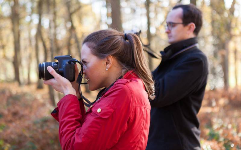 Woman taking a photograph of the landscape