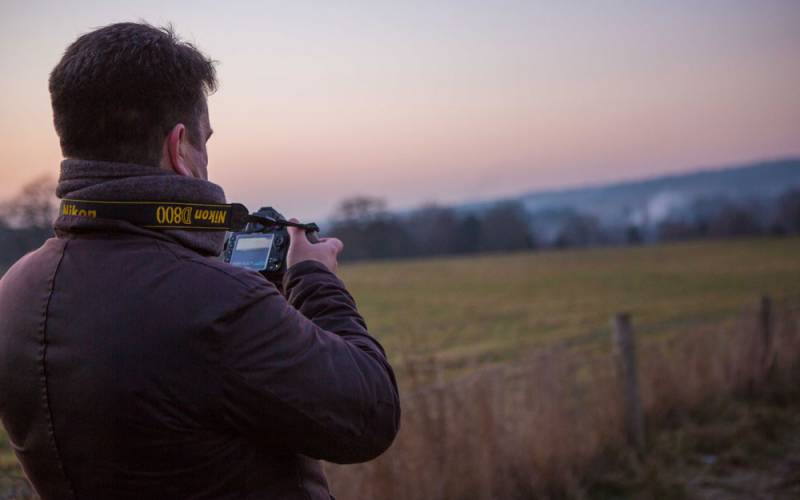 Man taking a photograph of the landscape