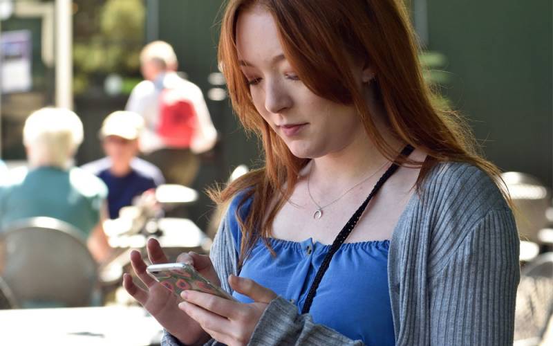 Visitor-on-her-phone-National-Trust-John-Millar